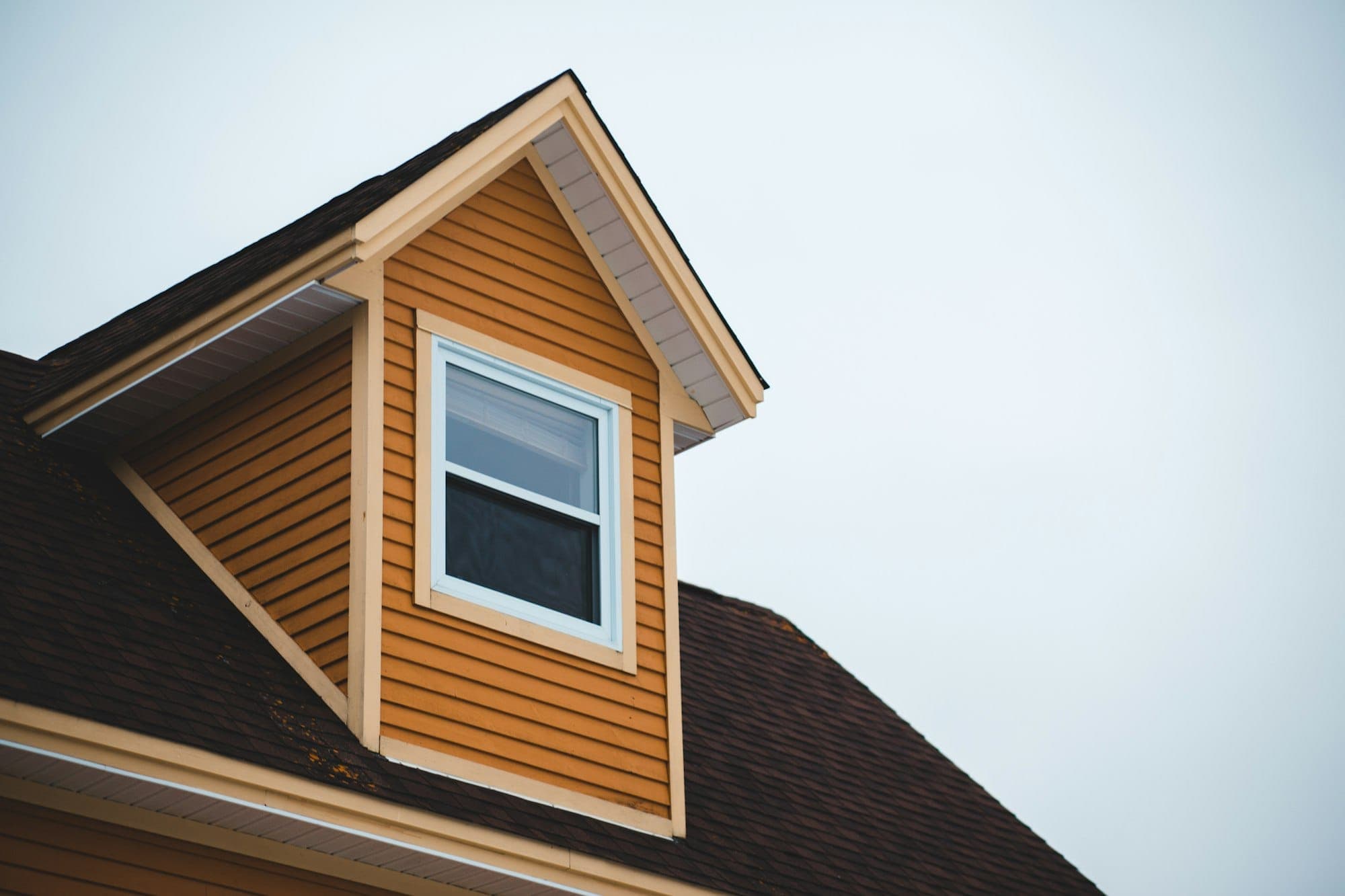 Amber lap siding and dormer detail on a home exterior